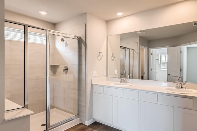 196 Lost Mine Peak Ln, Dripping Springs, TX 78620 - bathroom featuring a shower stall, double vanity, and wood finished floors