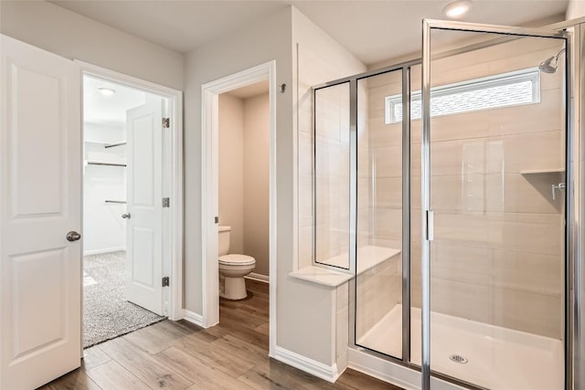 196 Lost Mine Peak Ln, Dripping Springs, TX 78620 - full bath with a stall shower, toilet, wood finished floors, and baseboards