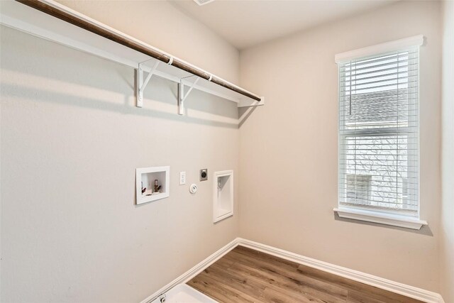 196 Lost Mine Peak Ln, Dripping Springs, TX 78620 - clothes washing area featuring hookup for an electric dryer, gas dryer hookup, wood finished floors, baseboards, and washer hookup