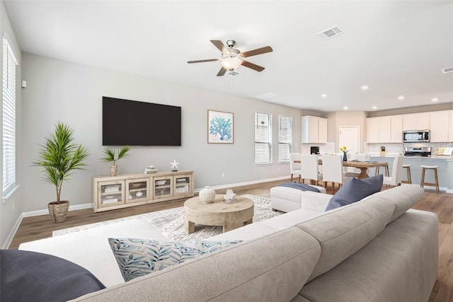 196 Lost Mine Peak Ln, Dripping Springs, TX 78620 - living area featuring light wood finished floors, a ceiling fan, baseboards, and recessed lighting