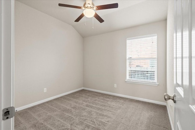 spare room with ceiling fan, lofted ceiling, and light carpet