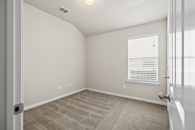 unfurnished room with light colored carpet and vaulted ceiling