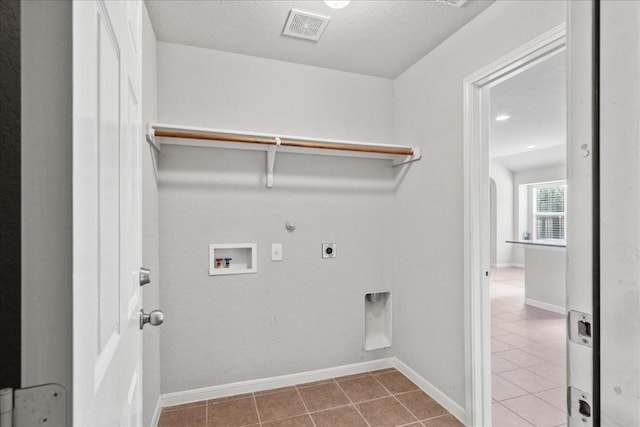 laundry area with tile patterned floors, hookup for a gas dryer, hookup for a washing machine, and hookup for an electric dryer