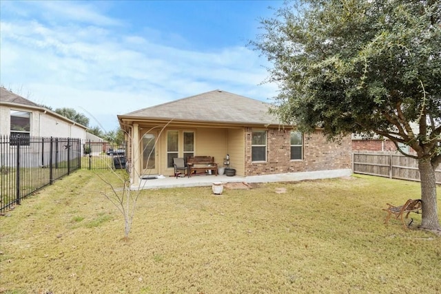 back of house with a yard and a patio area