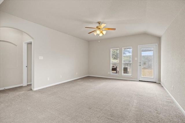 carpeted empty room featuring ceiling fan and vaulted ceiling