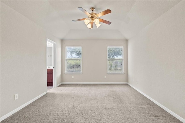 carpeted empty room featuring ceiling fan and vaulted ceiling