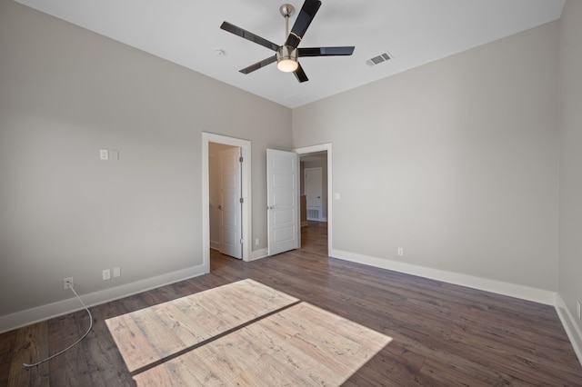 unfurnished bedroom featuring ceiling fan and dark wood-type flooring