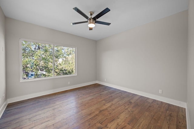 spare room featuring ceiling fan and dark hardwood / wood-style floors