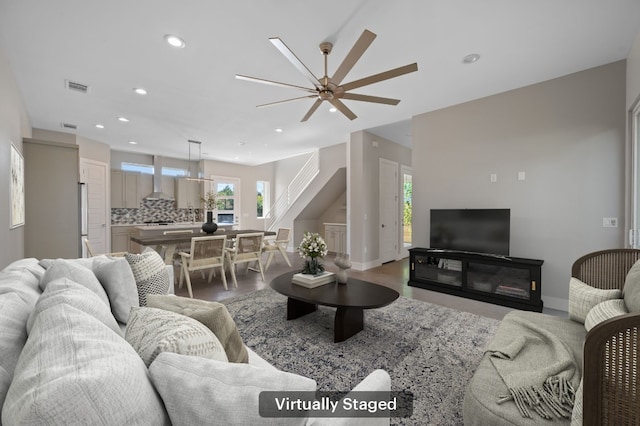 living room with ceiling fan and hardwood / wood-style floors