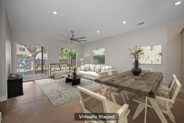 living room with concrete flooring and ceiling fan