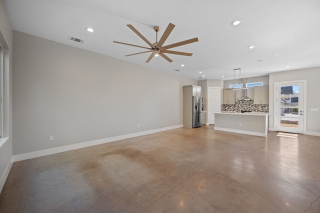 unfurnished living room featuring ceiling fan