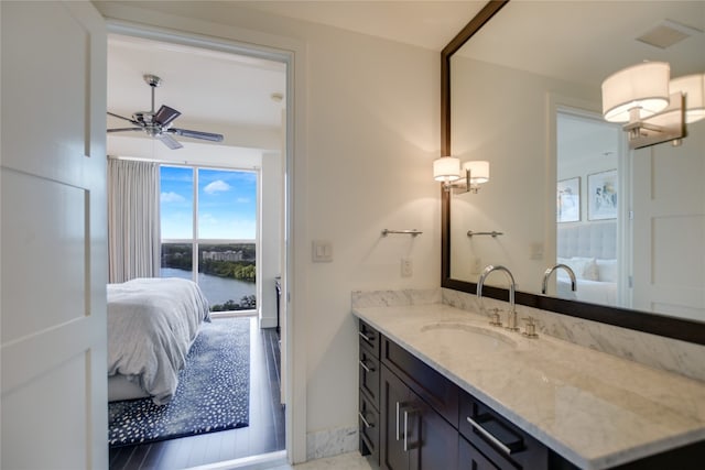 bathroom featuring vanity, hardwood / wood-style flooring, ceiling fan, and a water view