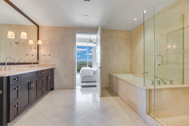 bathroom featuring ceiling fan, tile walls, and tile patterned floors