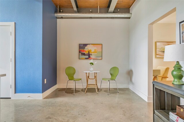 sitting room featuring wooden ceiling and beamed ceiling