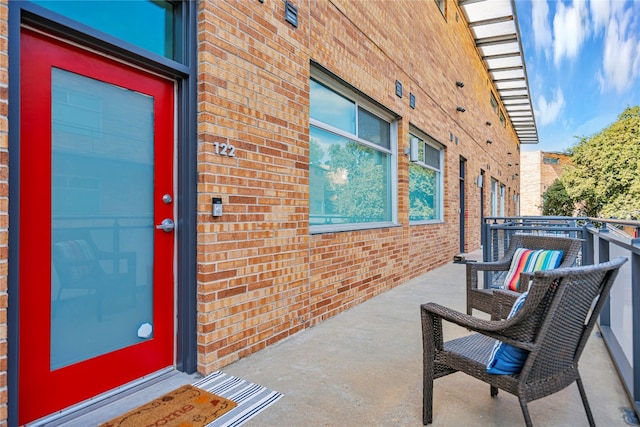 view of exterior entry featuring a balcony