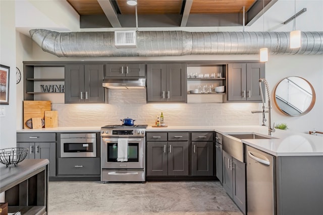 kitchen featuring stainless steel appliances, tasteful backsplash, beamed ceiling, gray cabinets, and wood ceiling