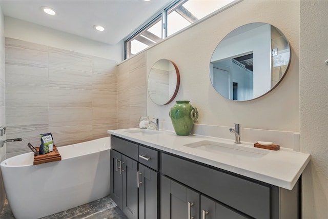 bathroom with vanity and a tub