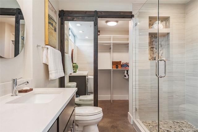 bathroom featuring vanity, concrete flooring, a shower with shower door, and toilet