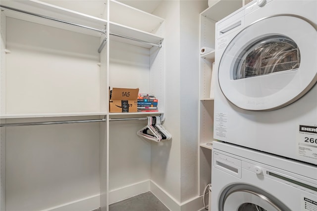 laundry room with stacked washer / dryer