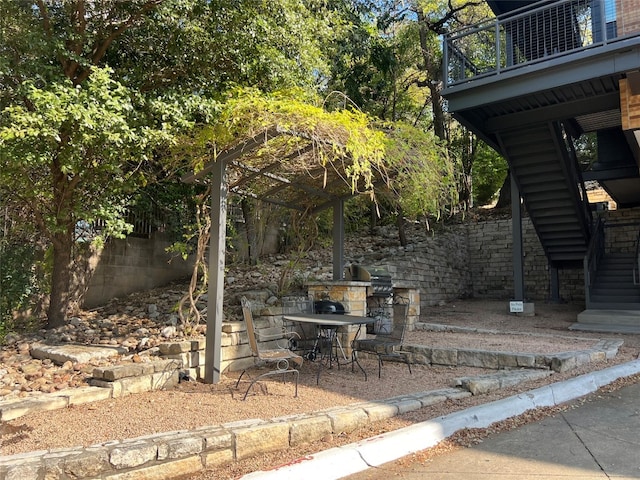 view of patio featuring a grill and a balcony