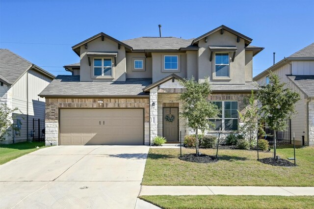 view of front of house featuring a front yard and a garage