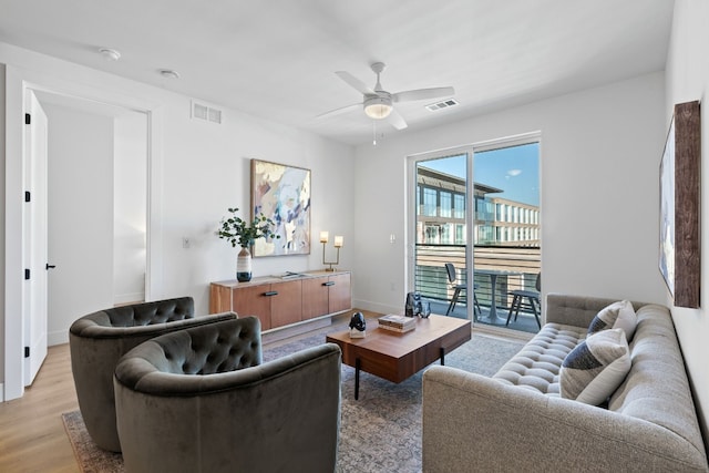 living room featuring light hardwood / wood-style flooring and ceiling fan