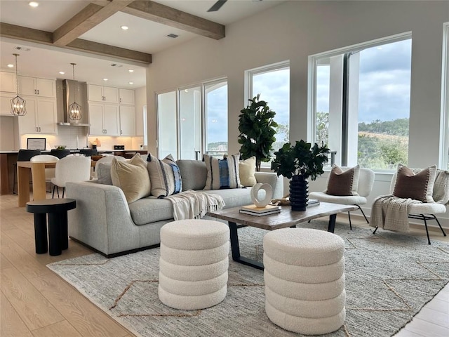 living area with a notable chandelier, beamed ceiling, recessed lighting, and light wood-style floors