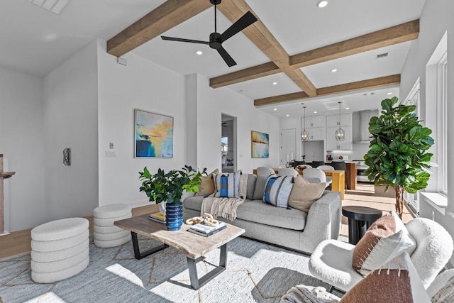 living area with beamed ceiling, recessed lighting, a ceiling fan, and light wood-style flooring