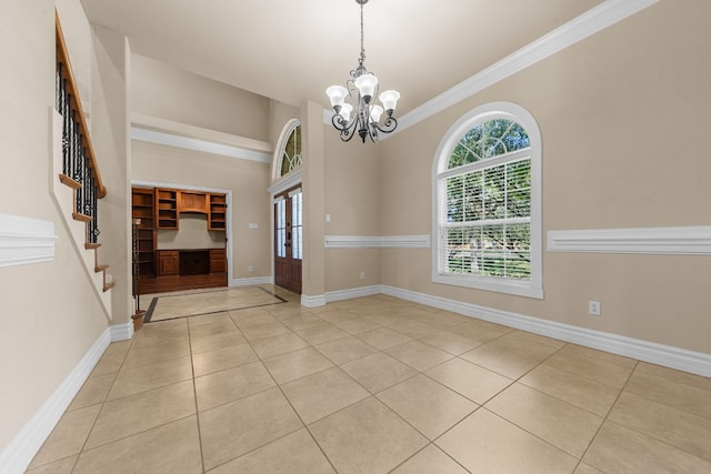 interior space with ornamental molding, a notable chandelier, and light tile patterned flooring