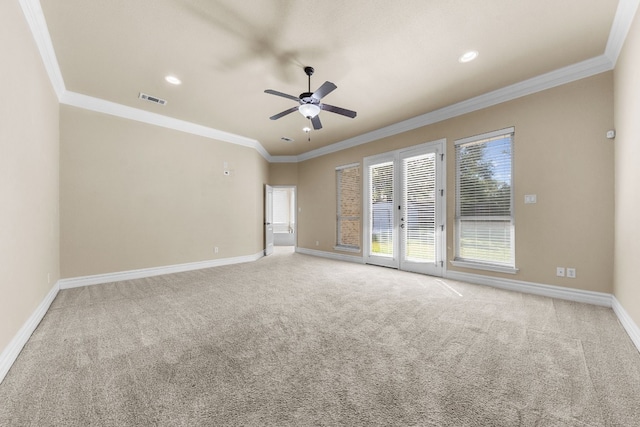 spare room with ceiling fan, carpet, crown molding, and french doors