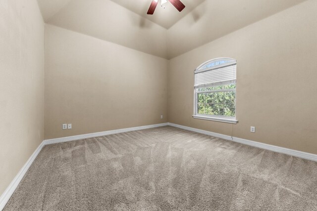 carpeted spare room featuring high vaulted ceiling and ceiling fan