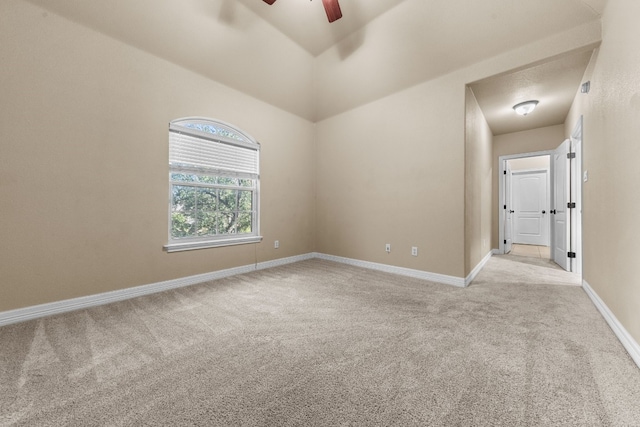 empty room featuring ceiling fan and light carpet