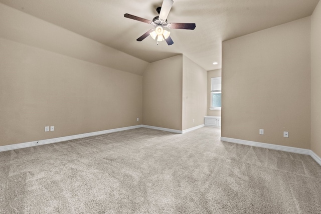 additional living space featuring vaulted ceiling, ceiling fan, and light carpet