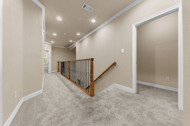 hall with light carpet and crown molding