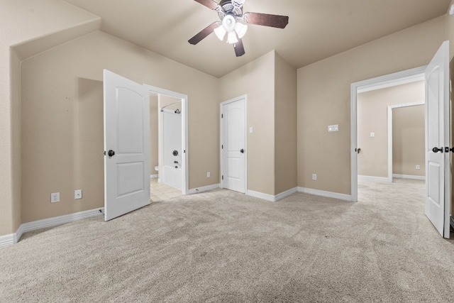 unfurnished bedroom with ensuite bath, ceiling fan, and light colored carpet