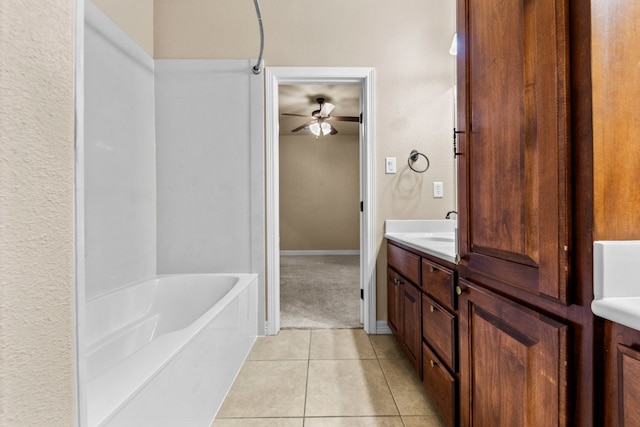 bathroom featuring tile patterned flooring, vanity, ceiling fan, and  shower combination