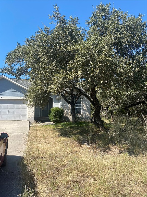 obstructed view of property with a garage