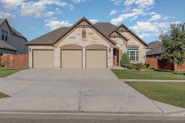 2104 Highland Ridge Rd, Georgetown, TX 78628 - french country home with stone siding, driveway, a garage, and roof with shingles