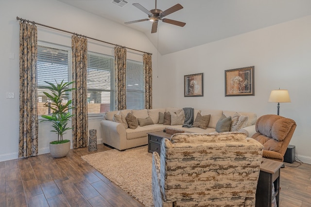 living room with vaulted ceiling, ceiling fan, and dark wood-type flooring