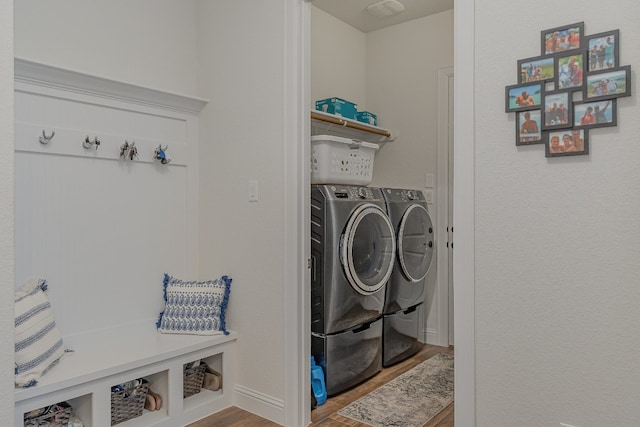 clothes washing area featuring hardwood / wood-style floors and separate washer and dryer