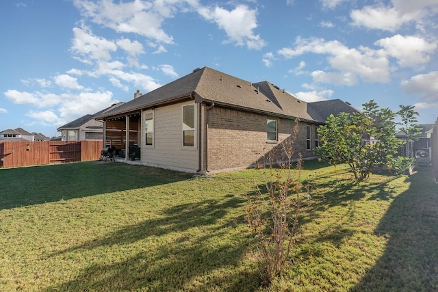 2104 Highland Ridge Rd, Georgetown, TX 78628 - rear view of house featuring a fenced backyard, brick siding, and a shingled roof