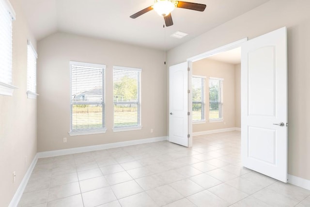 tiled empty room featuring ceiling fan and lofted ceiling