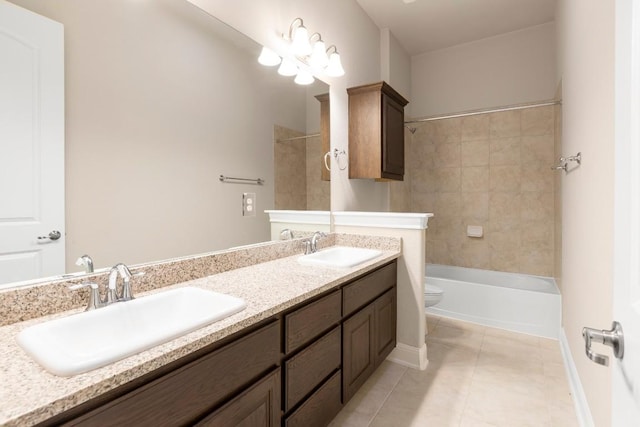 full bathroom featuring tile patterned floors, vanity, toilet, and tiled shower / bath combo