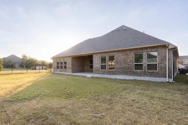 back of property with a patio area, a yard, and cooling unit