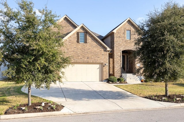 view of front of property with a garage and a front lawn