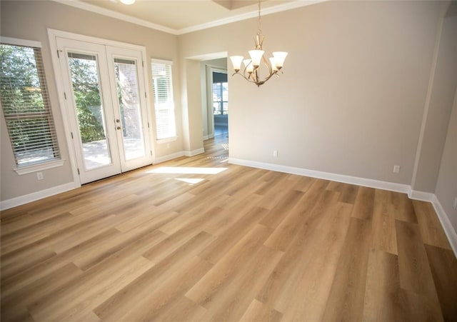 interior space featuring hardwood / wood-style flooring, a chandelier, ornamental molding, and french doors