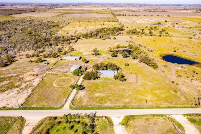 drone / aerial view featuring a rural view and a water view