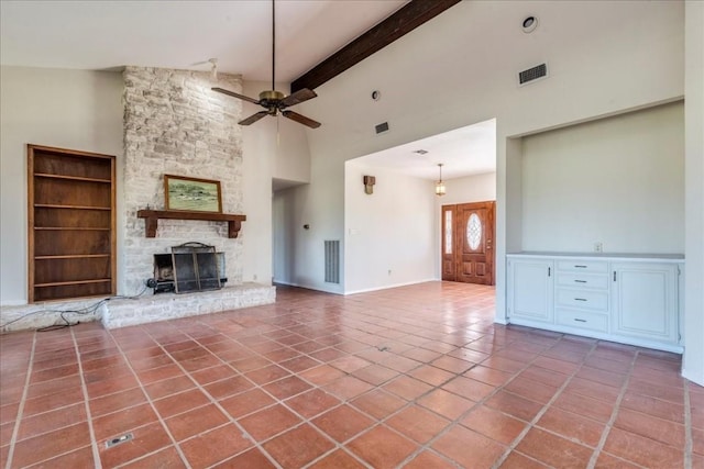 unfurnished living room with beamed ceiling, tile patterned flooring, high vaulted ceiling, and a fireplace