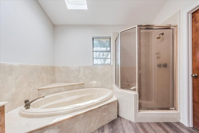 bathroom with a skylight, hardwood / wood-style floors, and plus walk in shower