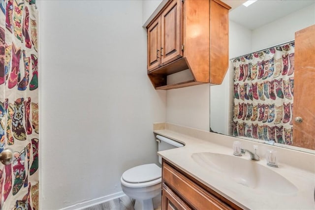 bathroom with a shower with curtain, vanity, toilet, and wood-type flooring